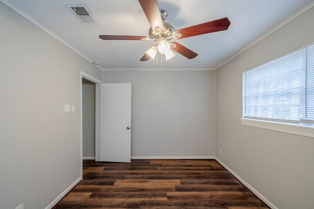 spare room with crown molding, ceiling fan, and dark wood-type flooring