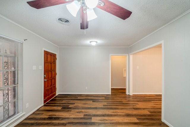 spare room with a textured ceiling, dark hardwood / wood-style floors, ceiling fan, and ornamental molding