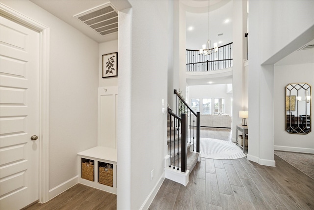 entryway featuring hardwood / wood-style flooring and an inviting chandelier