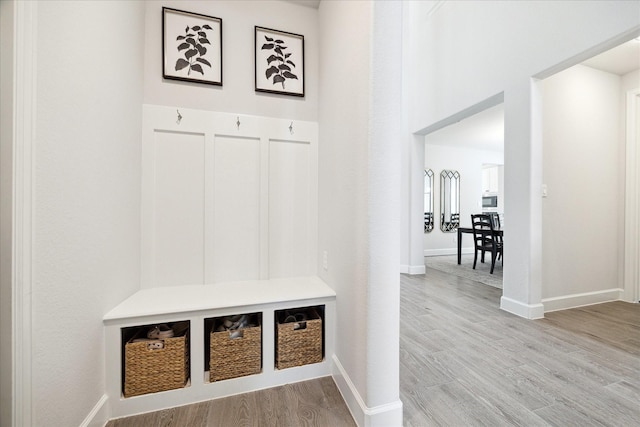 mudroom with light hardwood / wood-style flooring