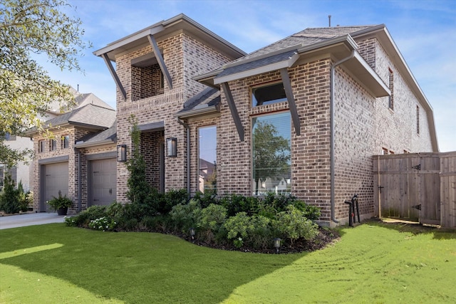 view of front of property with a front lawn and a garage