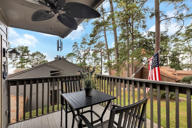 deck featuring a lawn and ceiling fan