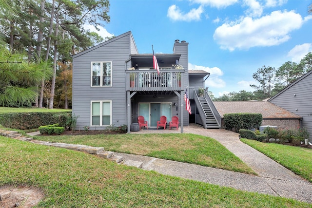 rear view of property with a patio area and a yard