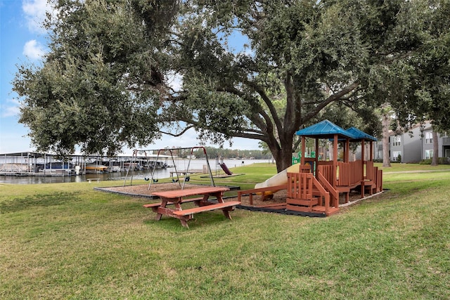 view of jungle gym with a water view and a yard