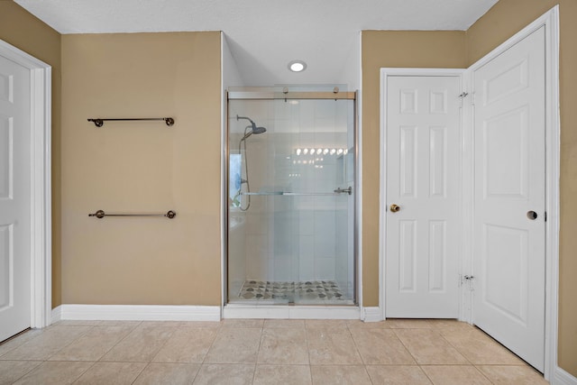 bathroom featuring tile patterned flooring, a textured ceiling, and walk in shower