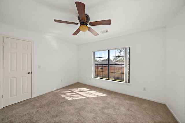 empty room with light colored carpet and ceiling fan