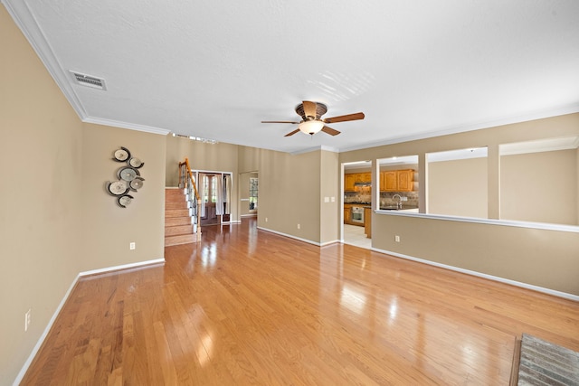 interior space with ceiling fan, light wood-type flooring, and ornamental molding