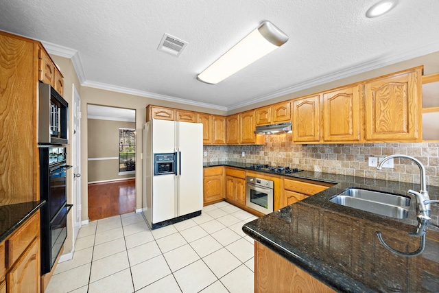 kitchen with black gas stovetop, ornamental molding, sink, light tile patterned floors, and white fridge with ice dispenser