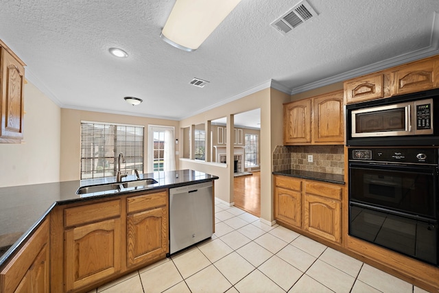 kitchen featuring decorative backsplash, sink, ornamental molding, and appliances with stainless steel finishes