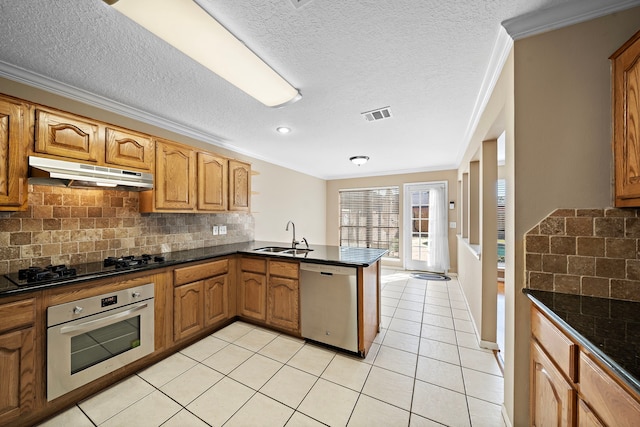 kitchen featuring sink, light tile patterned floors, ornamental molding, appliances with stainless steel finishes, and kitchen peninsula