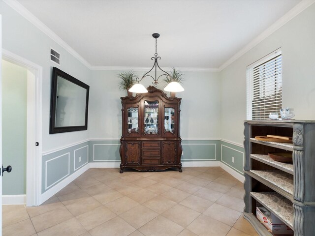 dining room with ornamental molding and a chandelier