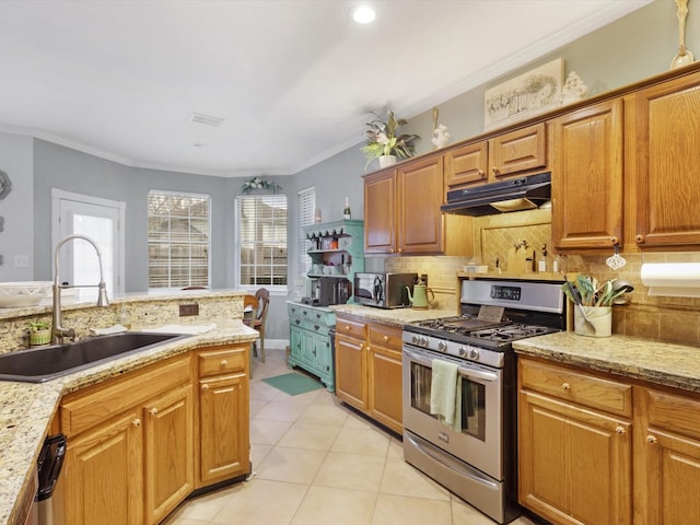 kitchen with light stone countertops, sink, backsplash, crown molding, and appliances with stainless steel finishes