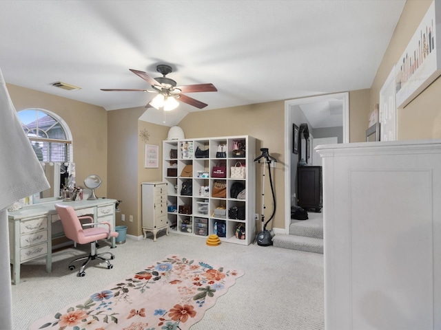 carpeted home office featuring ceiling fan