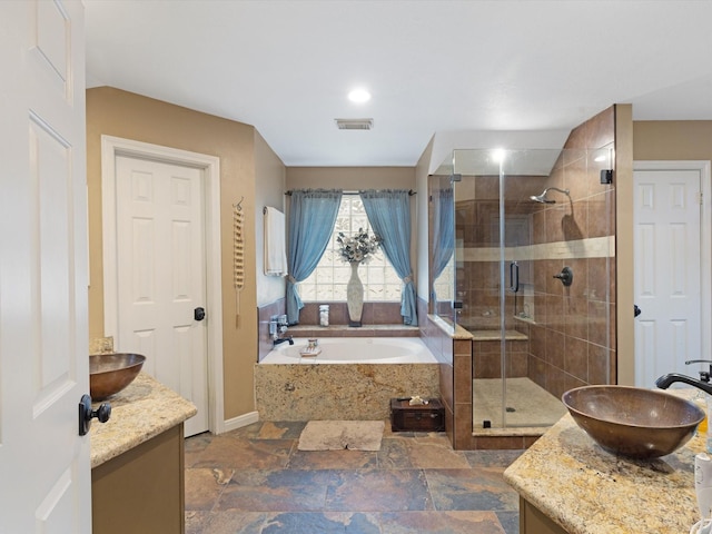 bathroom with shower with separate bathtub and vanity