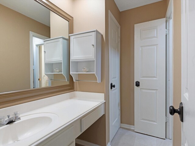 bathroom with tile patterned flooring and vanity