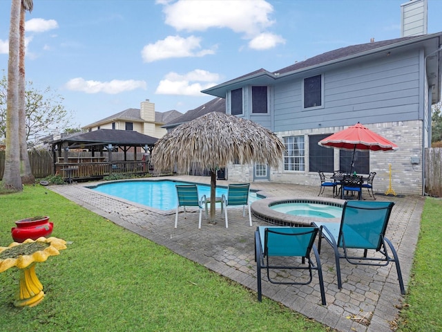 view of pool with a patio area, a gazebo, an in ground hot tub, and a lawn