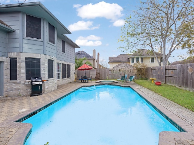 view of swimming pool featuring a grill, an in ground hot tub, and a patio