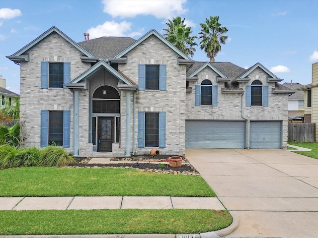 view of front of property featuring a garage and a front lawn