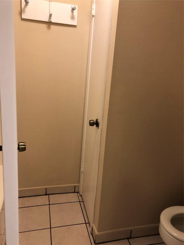 bathroom featuring toilet and tile patterned floors