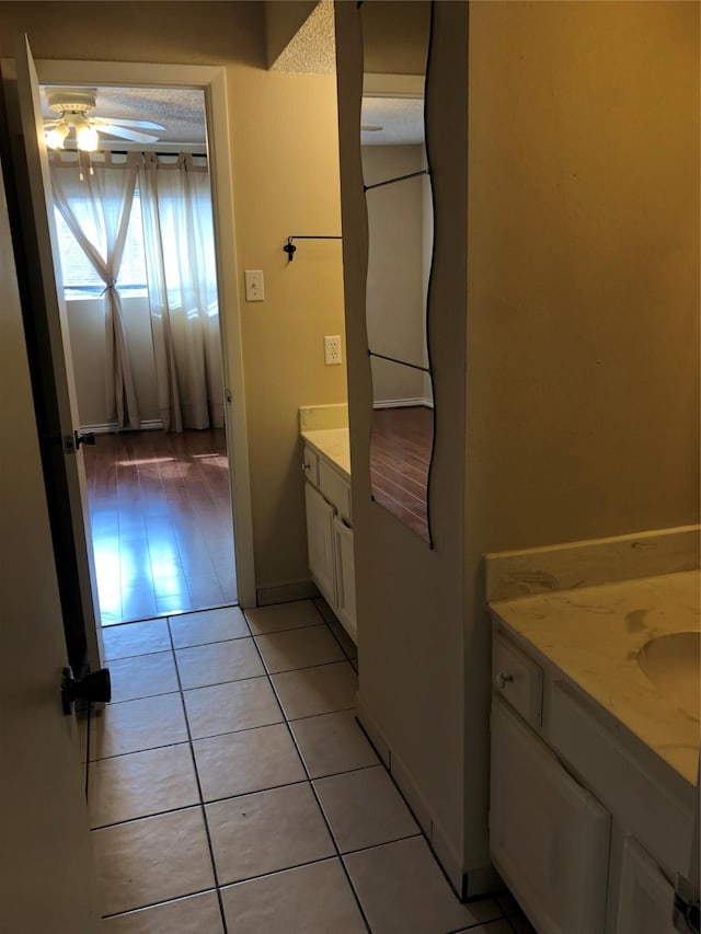 bathroom featuring wood-type flooring, vanity, and ceiling fan