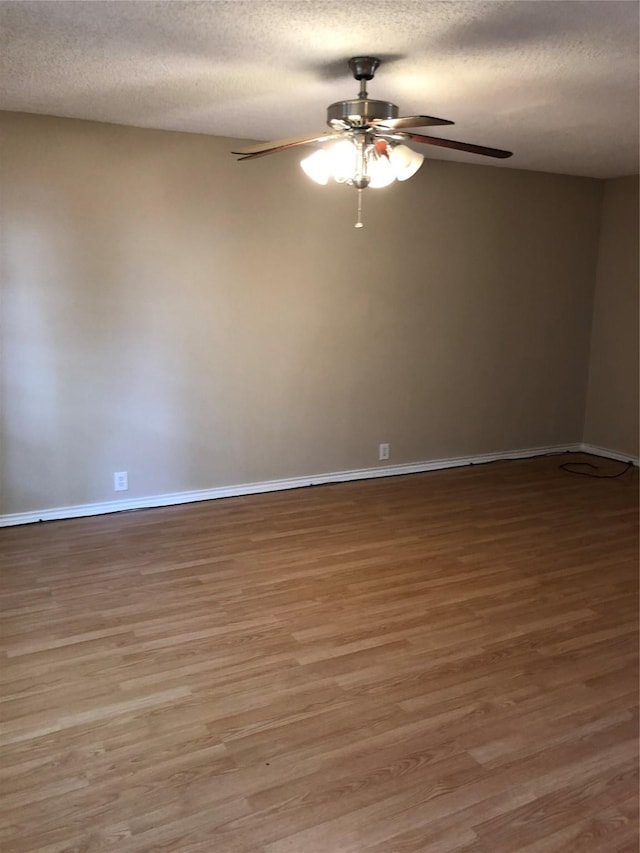 unfurnished room featuring ceiling fan, a textured ceiling, and hardwood / wood-style flooring