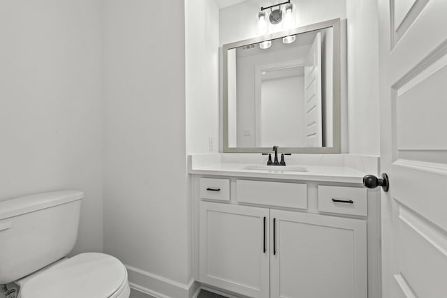 bathroom featuring vanity and toilet