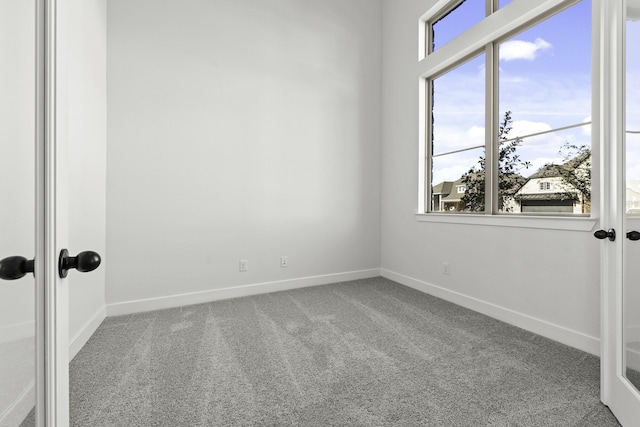 carpeted empty room with french doors