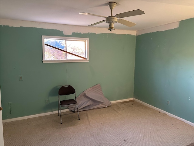 unfurnished room featuring light carpet and ceiling fan