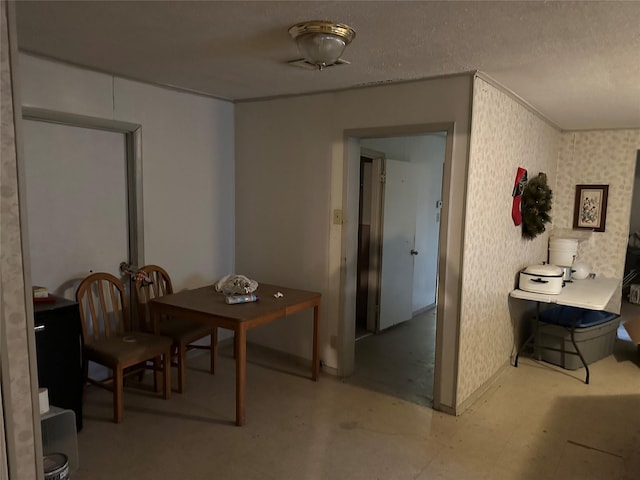 dining area featuring a textured ceiling