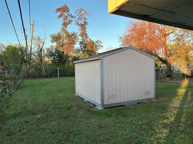 view of outdoor structure featuring a lawn