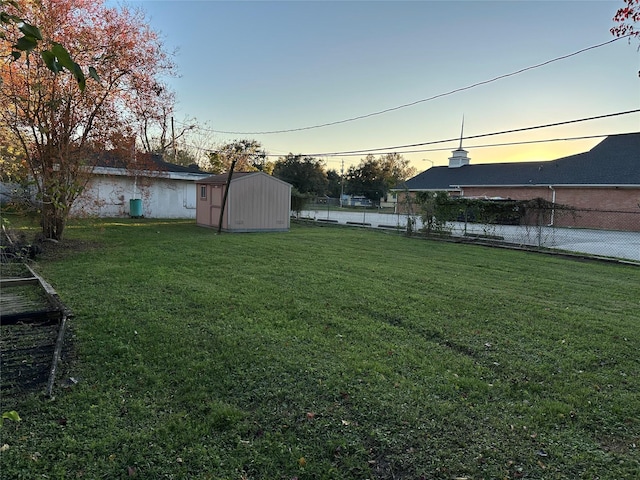 yard at dusk with a storage unit