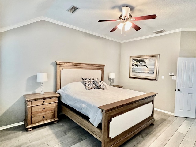 bedroom with ceiling fan, crown molding, and light hardwood / wood-style floors