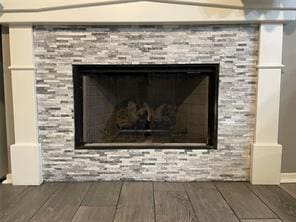 interior details with hardwood / wood-style flooring and a fireplace