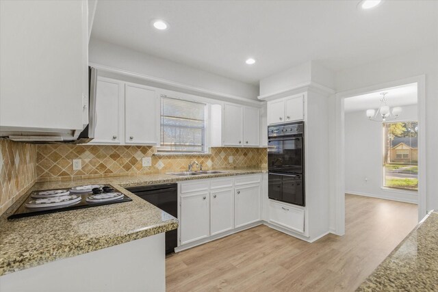 kitchen featuring sink, white cabinets, pendant lighting, and light wood-type flooring