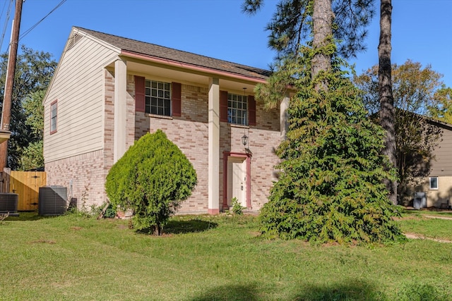 view of front of property featuring central AC and a front lawn