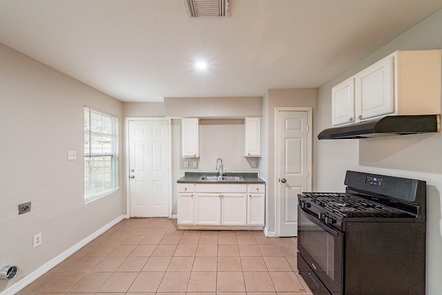 kitchen featuring light tile patterned flooring, black gas stove, white cabinetry, and sink