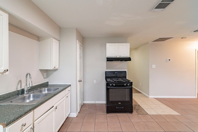 kitchen with sink, white cabinets, black gas range oven, and light tile patterned floors