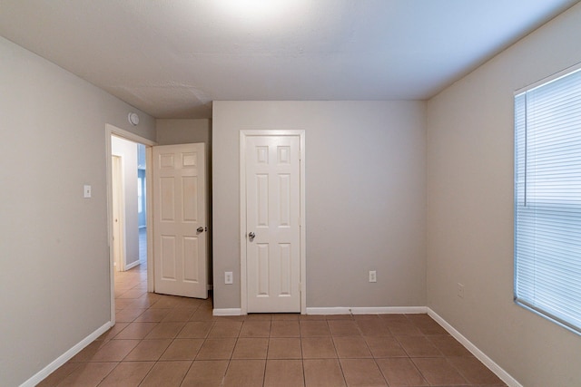 unfurnished bedroom featuring light tile patterned floors