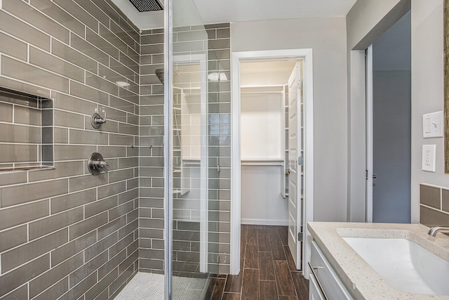 bathroom with vanity, hardwood / wood-style flooring, and walk in shower