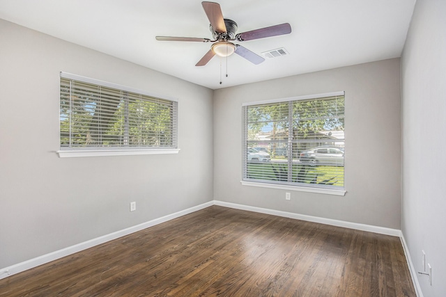 unfurnished room with ceiling fan, dark hardwood / wood-style flooring, and a wealth of natural light