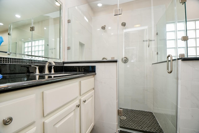 bathroom with vanity and a shower with shower door