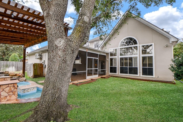 rear view of property with a lawn and a sunroom