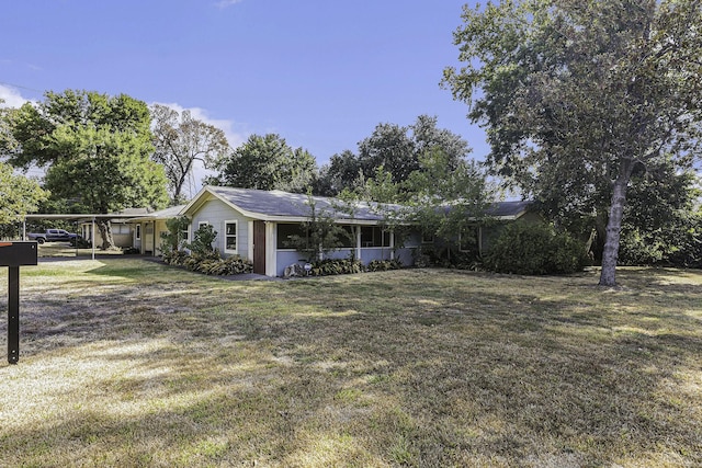 single story home with a carport and a front lawn