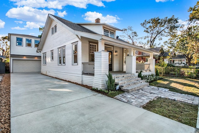 view of front of property with a porch and a garage