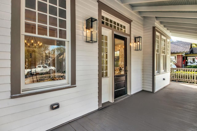 view of exterior entry with covered porch