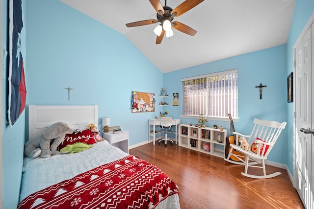 bedroom with ceiling fan, dark hardwood / wood-style flooring, and vaulted ceiling