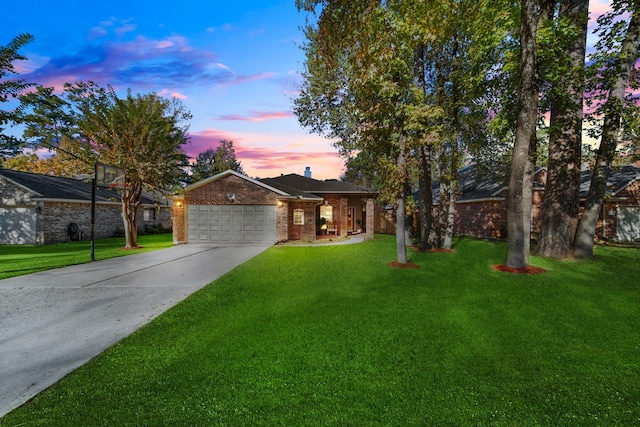 view of front of property with a garage and a lawn