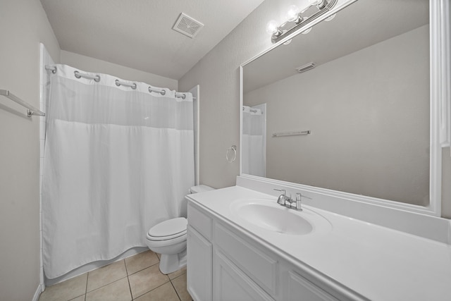 bathroom featuring vanity, tile patterned floors, toilet, a textured ceiling, and curtained shower