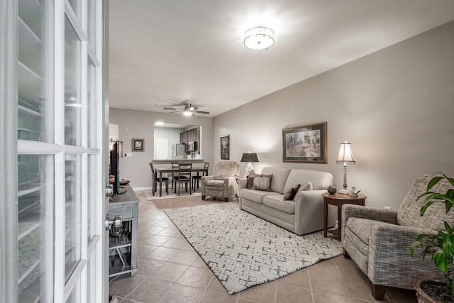 living room featuring light tile patterned floors and ceiling fan