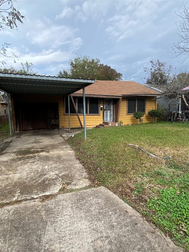 ranch-style home with a carport and a front lawn